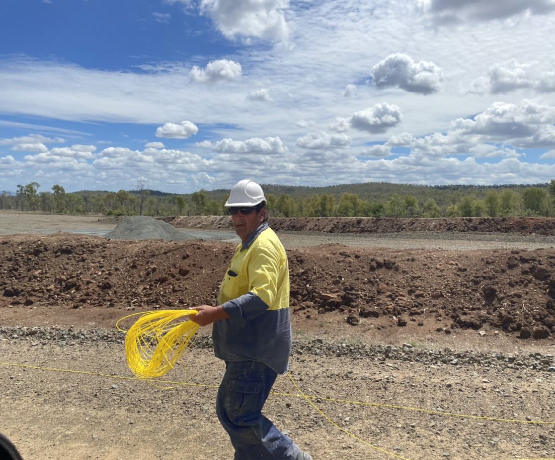 Shotfirer laying out lead-in line on a blast